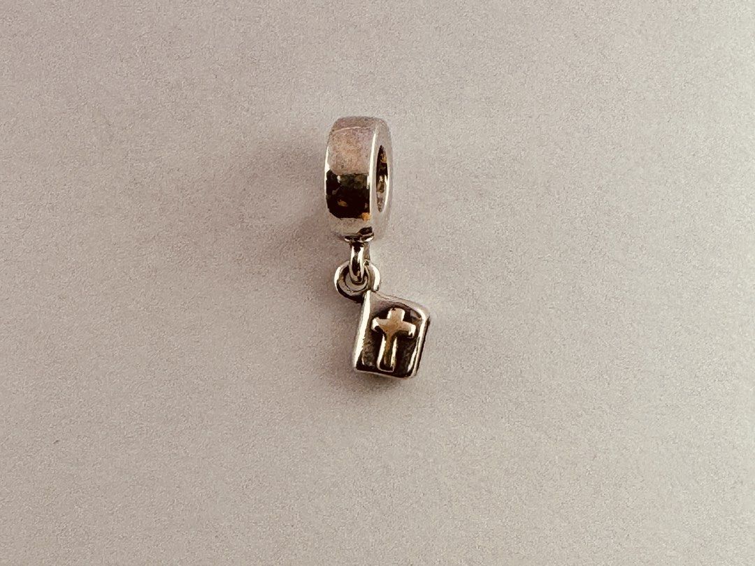 Pandora Holy Bible Dangle Charm (790409) (Category: Charms) located in Cabanatuan. Submitted by water.withahintoflime (Listing ID 1461262487, Image 1). Description: Retired|Authentic Rare S925 Body|Yellow G585 Cross (both sides) 925 ALE Hallmark Pre-owed|No issue|Normal wear With complete packaging.