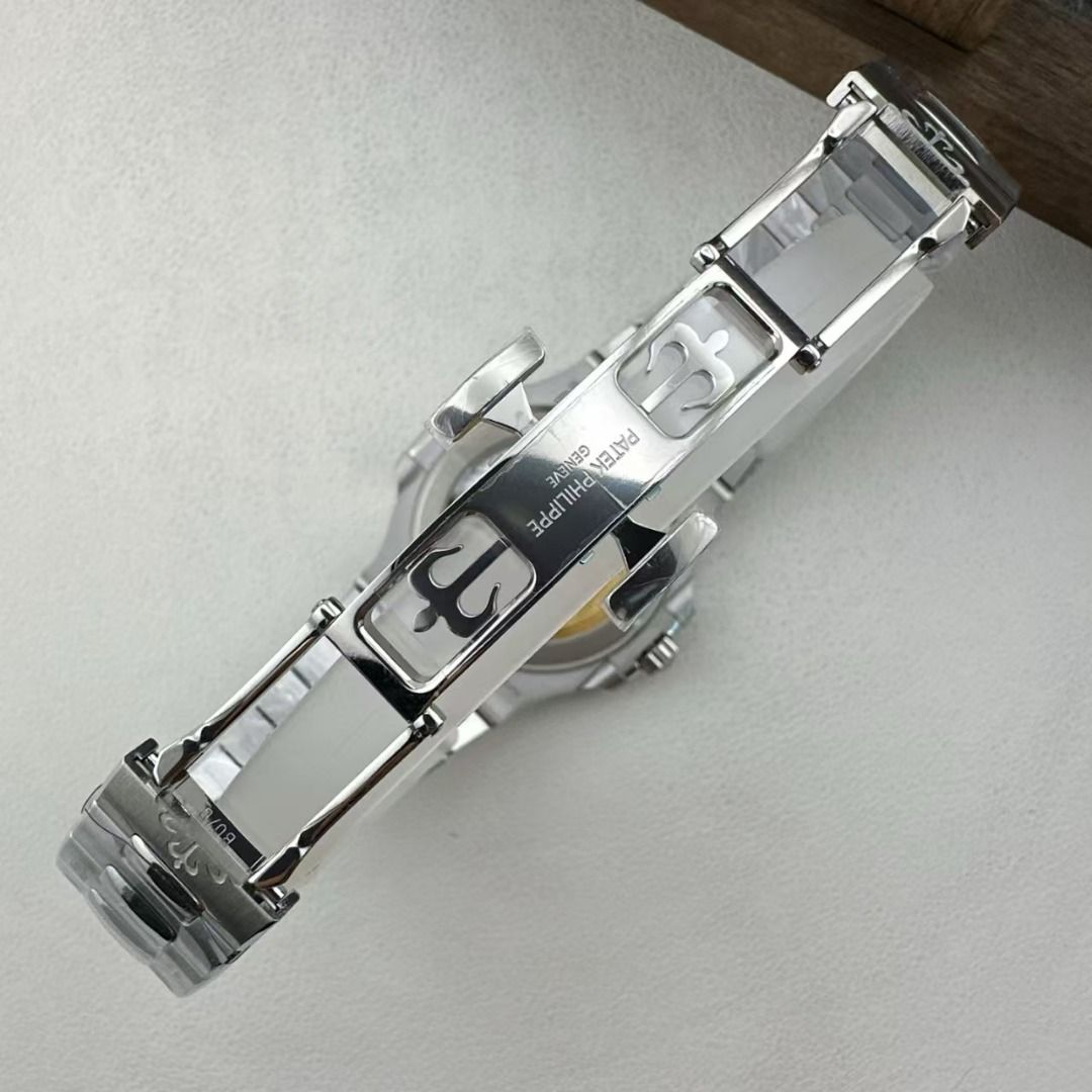 Patek Philippe Nautilus Sapphire Dial Watch (Category: Luxury Watches) located in Manila. Submitted by brangelepo03216 (Listing ID 1466205295, Image 2). Description: Patek Philippe Nautilus automatic watch. Stainless steel case and bracelet, exhibition caseback showing movement. Black horizontally embossed dial set with blue baguette hour markers. Date window at 3 o'clock. Double folding clasp stamped with Calatrava cross. Protective plastic wrap