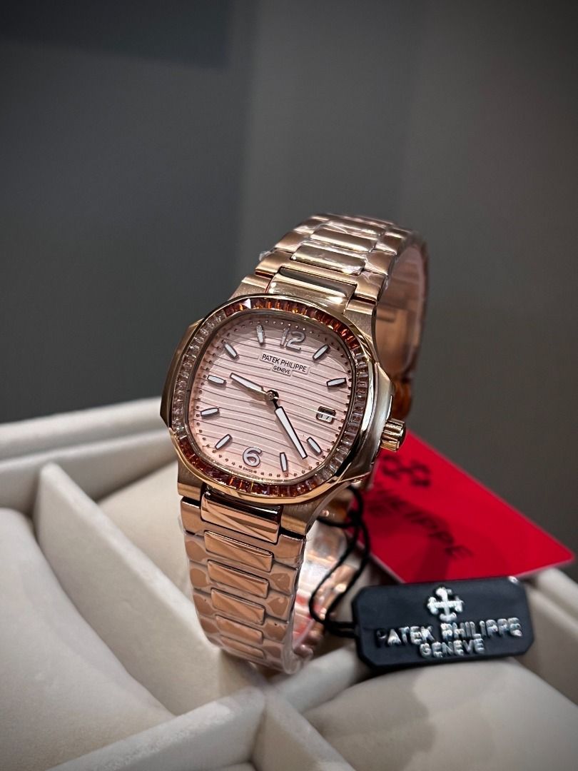Patek Philippe Rose Gold Watch with Gemstone Bezel (Category: Luxury Watches) located in Pasig City. Submitted by wisefalcon6199 (Listing ID 1466227363, Image 3). Description: - Rose gold tone luxury watch with a stunning gemstone-set bezel in warm orange and brown tones - Textured dial featuring elegant baguette hour markers, Arabic numerals at 12 and 6, and a practical date window - Matching metal link bracelet, brand new and wrapped in protect