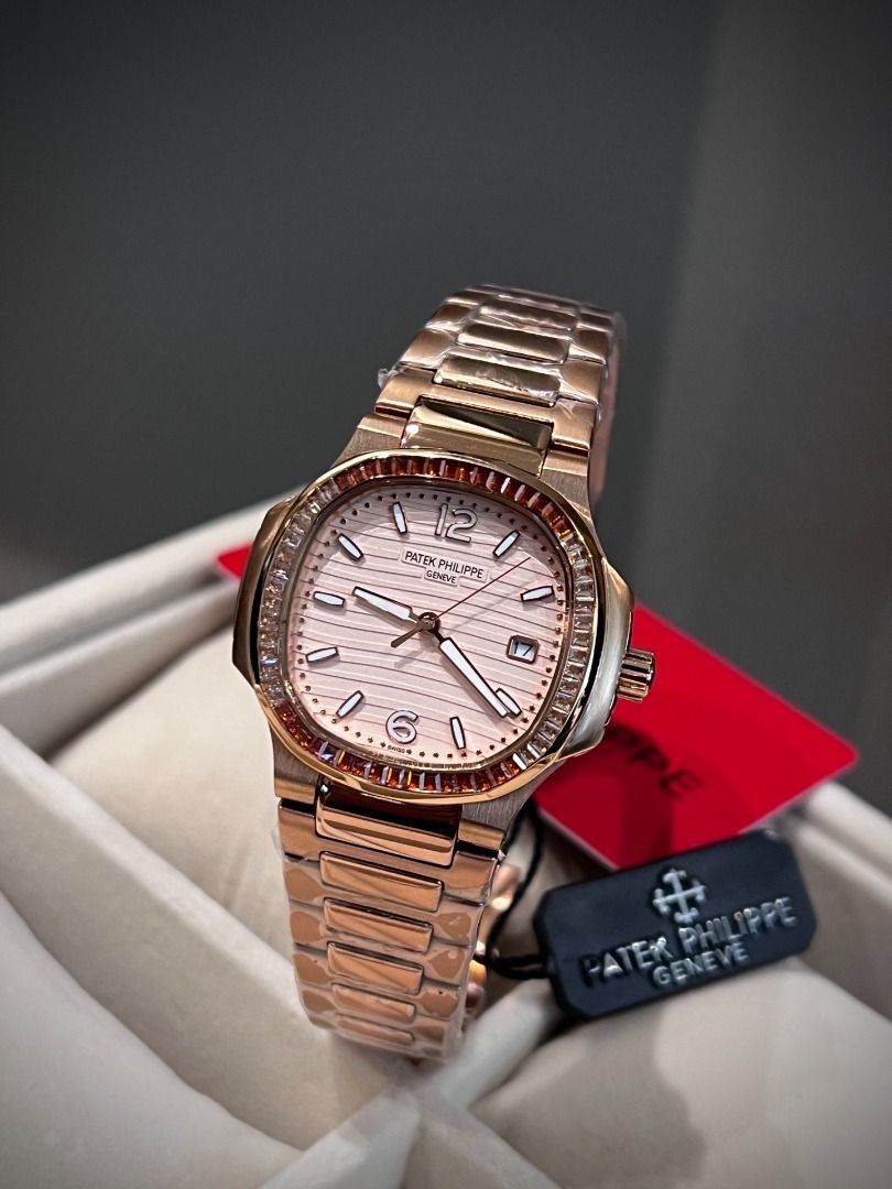 Patek Philippe Rose Gold Watch with Gemstone Bezel (Category: Luxury Watches) located in Pasig City. Submitted by wisefalcon6199 (Listing ID 1466227363, Image 1). Description: - Rose gold tone luxury watch with a stunning gemstone-set bezel in warm orange and brown tones - Textured dial featuring elegant baguette hour markers, Arabic numerals at 12 and 6, and a practical date window - Matching metal link bracelet, brand new and wrapped in protect