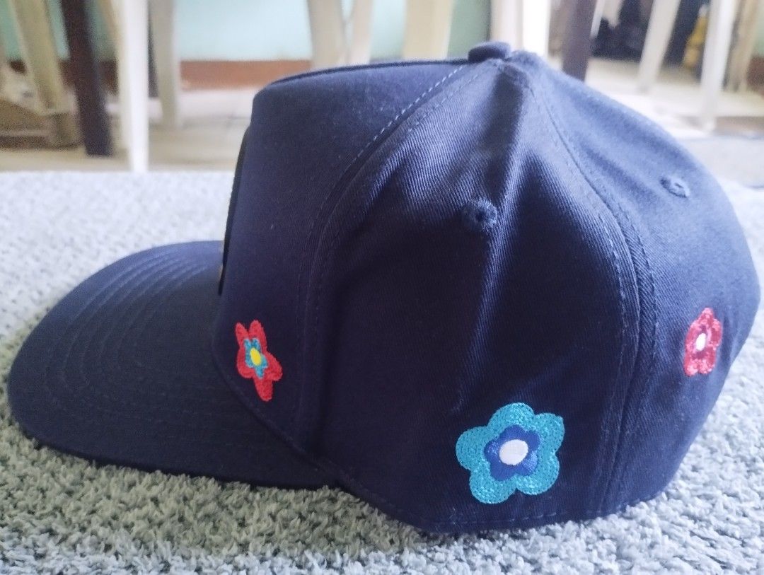 PD Club Good Things Are Coming Snapback Hat (Category: Caps & Hats) located in Manila. Submitted by happycaps (Listing ID 1466173638, Image 2). Description: - Brand: Problematic and Dangerous Club - Color: Navy blue - Design: Large rubberized 'Good Things Are Coming' smiley patch on the front - Details: Embroidered flowers on the sides and a rose graphic on the lower side panel - Fit: Adjustable snapback closure with PD Club tag - Interior: Brand
