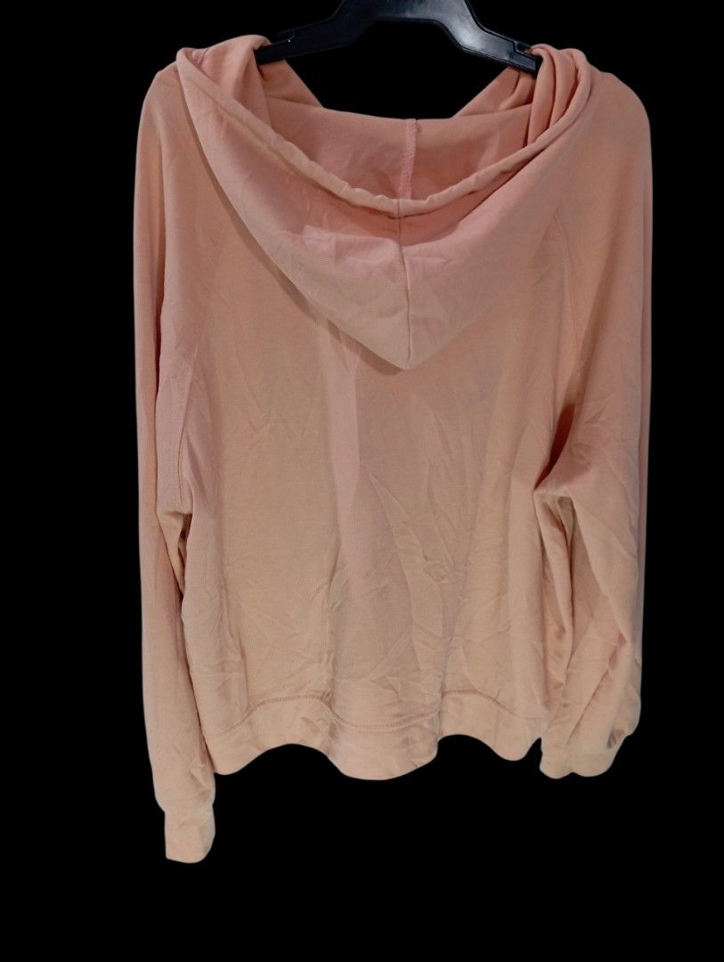 Peach Hoodie with Snap Buttons and Drawstrings Size Small (Category: Coats, Jackets and Outerwear) located in Rodriguez. Submitted by enzo.tv (Listing ID 1466326297, Image 3). Description: - Color: Peach - Size: Women's Small (Length: 17", Width: 15.5") - Design: Snap button front placket with four silver-tone buttons, matching pink drawstrings, and long sleeves - Fit: Relaxed and comfortable - Flaw: Small stain visible on the front fabric.