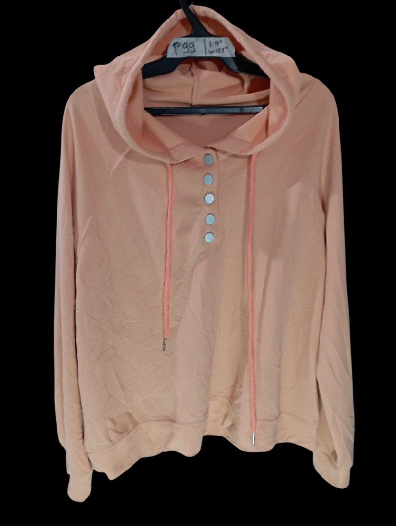 Peach Hoodie with Snap Buttons and Drawstrings Size Small (Category: Coats, Jackets and Outerwear) located in Rodriguez. Submitted by enzo.tv (Listing ID 1466326297, Image 2). Description: - Color: Peach - Size: Women's Small (Length: 17", Width: 15.5") - Design: Snap button front placket with four silver-tone buttons, matching pink drawstrings, and long sleeves - Fit: Relaxed and comfortable - Flaw: Small stain visible on the front fabric.
