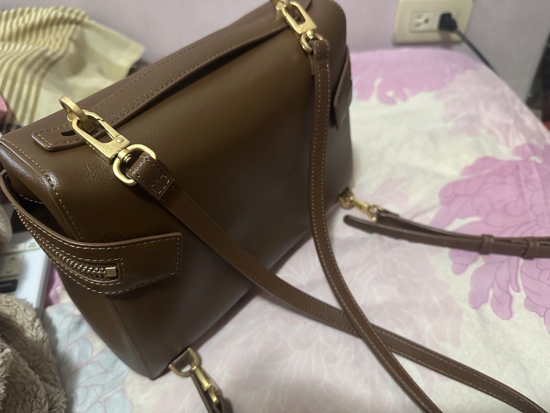Pedro Genuine Leather Backpack (Category: Shoulder Bags) located in Mandaluyong City. Submitted by jeninaheart (Listing ID 1466159662, Image 3). Description: - Brand: Pedro - Material: Brown leather with clean stitching - Hardware: Gold-tone - Closure: Zipper across the front flap - Strap: Adjustable and detachable via lobster clasps - Interior: Beige lining with an inner zipper pocket and brand tag.