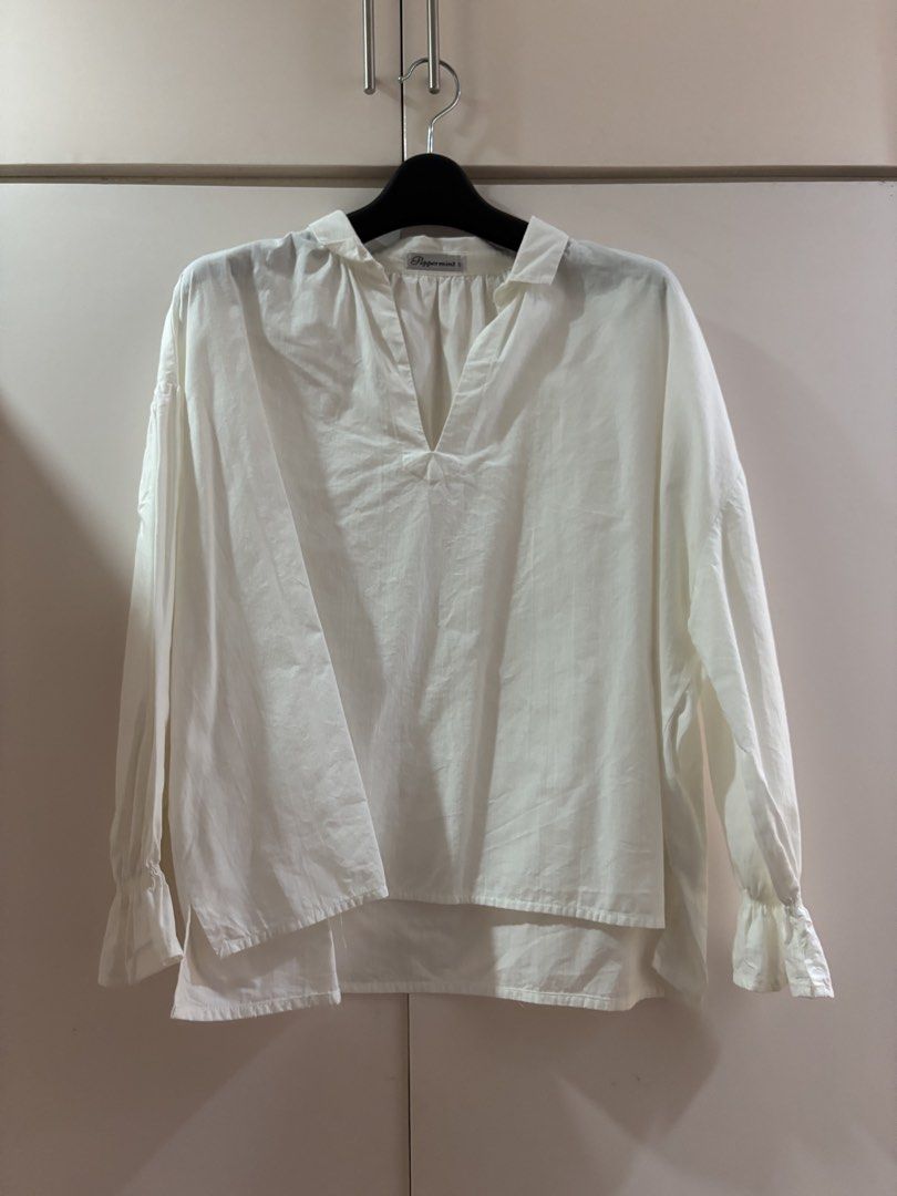 Peppermint White V-Neck Long Sleeve Blouse (Category: Longsleeves) located in Las Pinas. Submitted by misg0905 (Listing ID 1466244800, Image 1). Description: - Brand: Peppermint - Color: Classic White - Style: Long sleeve blouse with deep V-neck and pleated front details - Fit: Relaxed fit with a trendy high-low hem - Cuffs: Chic ruffled sleeves - Fabric: Lightweight and breathable - Perfect for: Workwear, casual outings, or smart-casual looks.
