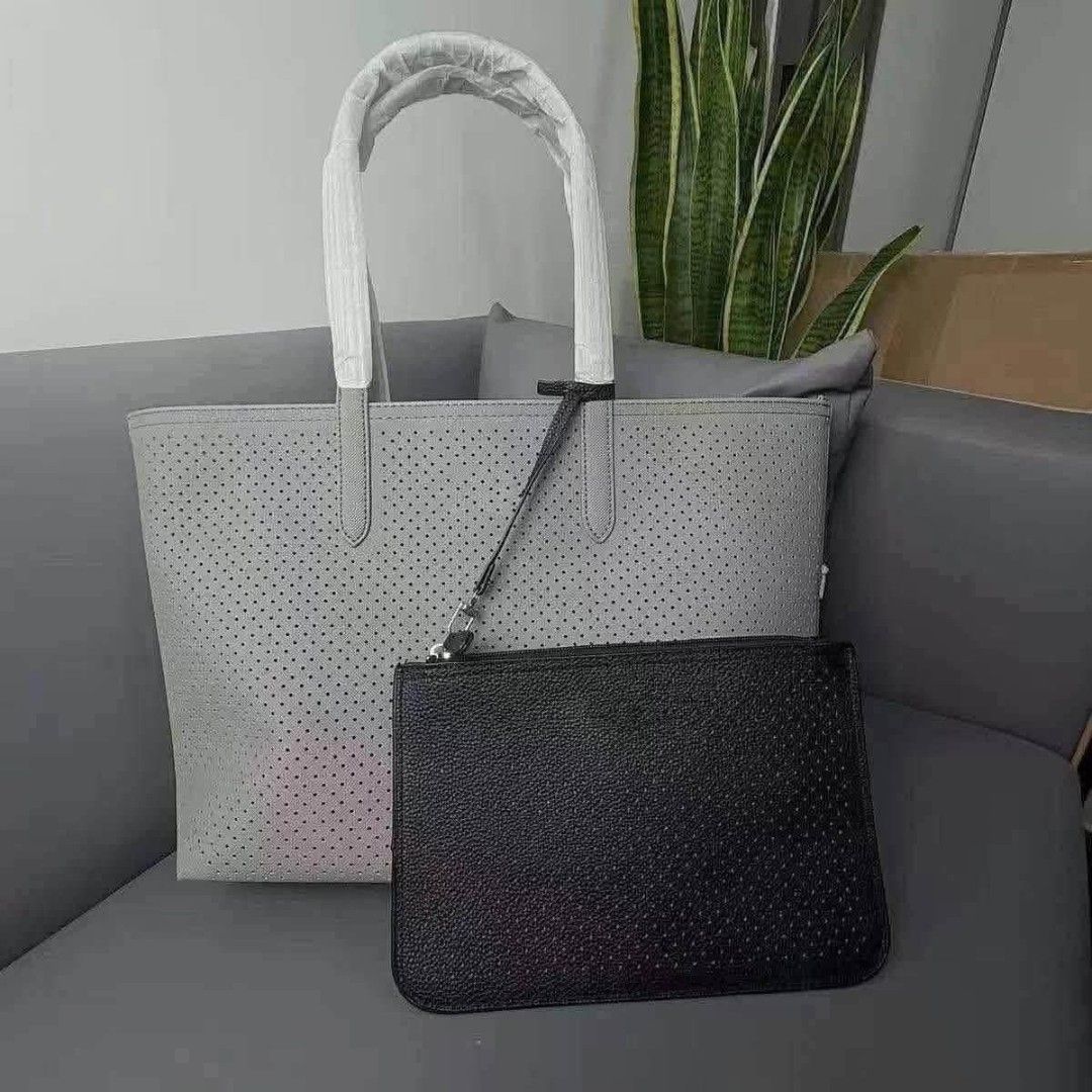 Perforated Tote Bag with Matching Pouch Set (Category: Tote Bags) located in Manila. Submitted by onlineshopmate (Listing ID 1466182892, Image 2). Description: - Trendy perforated design tote bag with matching clutch pouch - Spacious interior, perfect for daily use and errands - Secure zippered pouch attached via a slim strap - Handles wrapped in protective foam for safe shipping and comfy grip - Available color combos: Beige/White, Grey/Black, a