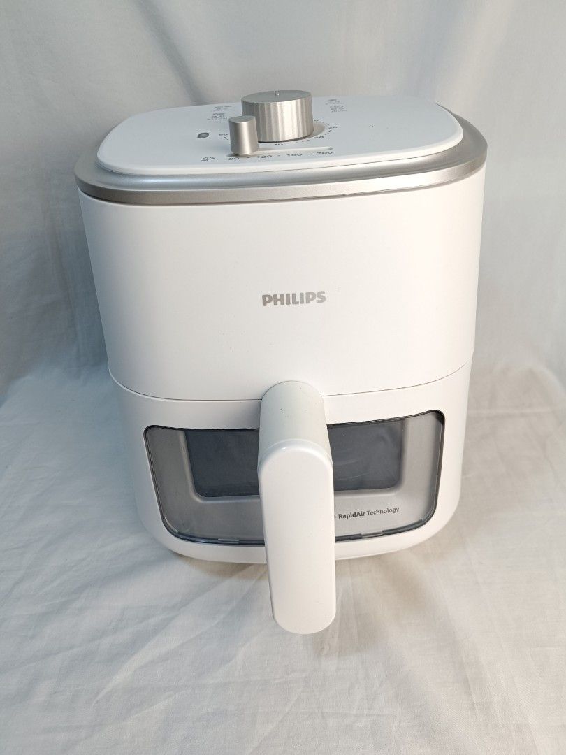 Philips Air Fryer White RapidAir Technology (Category: Fryers) located in Baguio. Submitted by clothes.over.bros.ph_2020 (Listing ID 1466268601, Image 1). Description: - Authentic Philips Air Fryer in clean white finish - Dual manual knobs for easy time and temperature control - Built-in viewing window on the basket to monitor food while cooking - Clean internal heating element and fan - Includes non-stick basket and removable mesh tray insert - 