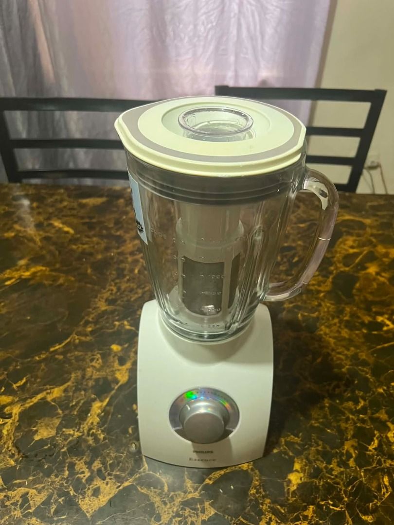 Philips Pure Essentials Collection Blender (Category: Juicers, Blenders & Grinders) located in Taguig. Submitted by lhadychinitah (Listing ID 1466238803, Image 2). Description: - Brand: Philips Pure Essentials Collection (Essence) - Color: White base with clear glass jar - Condition: Good working condition, well-maintained - Features: Multi-speed dial with pulse function, built-in cord storage at the base - Includes: Glass jar, lid, measuring cup