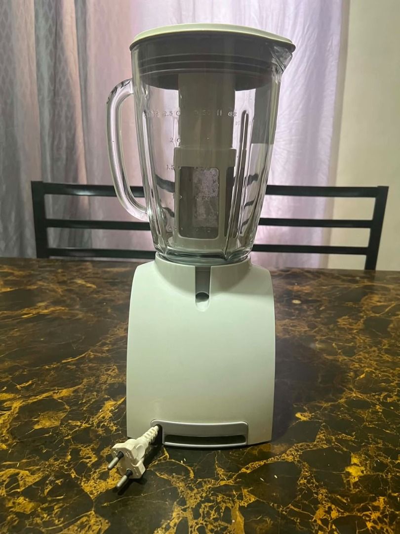 Philips Pure Essentials Collection Blender (Category: Juicers, Blenders & Grinders) located in Taguig. Submitted by lhadychinitah (Listing ID 1466238803, Image 3). Description: - Brand: Philips Pure Essentials Collection (Essence) - Color: White base with clear glass jar - Condition: Good working condition, well-maintained - Features: Multi-speed dial with pulse function, built-in cord storage at the base - Includes: Glass jar, lid, measuring cup