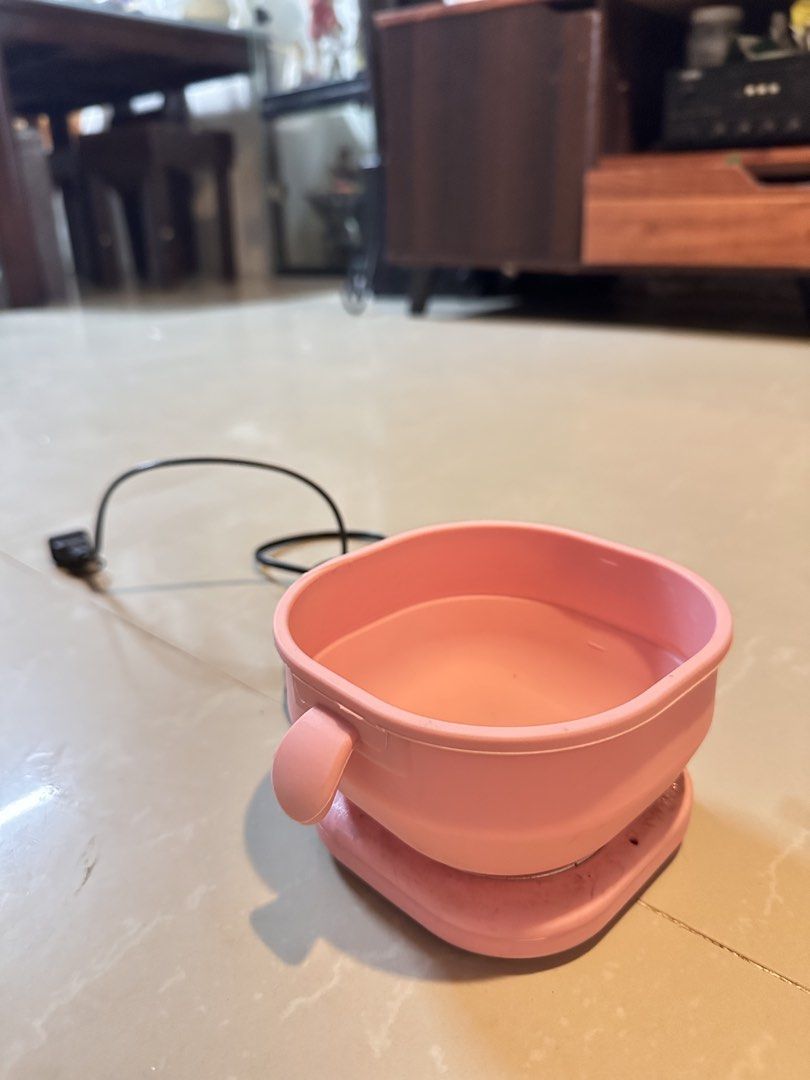 Pink Portable Electric wax heater (Category: Cookers) located in Manila. Submitted by mysticdog_8e9243 (Listing ID 1466181849, Image 1). Description: - Color: Cute pastel pink - Compact and portable design, ideal for dorms, offices, and small spaces - Features a detachable bowl and integrated heating plate with safety warning symbol - Plugs into standard wall outlets with the included black power cord - Clean, working well, and easy to pack away 