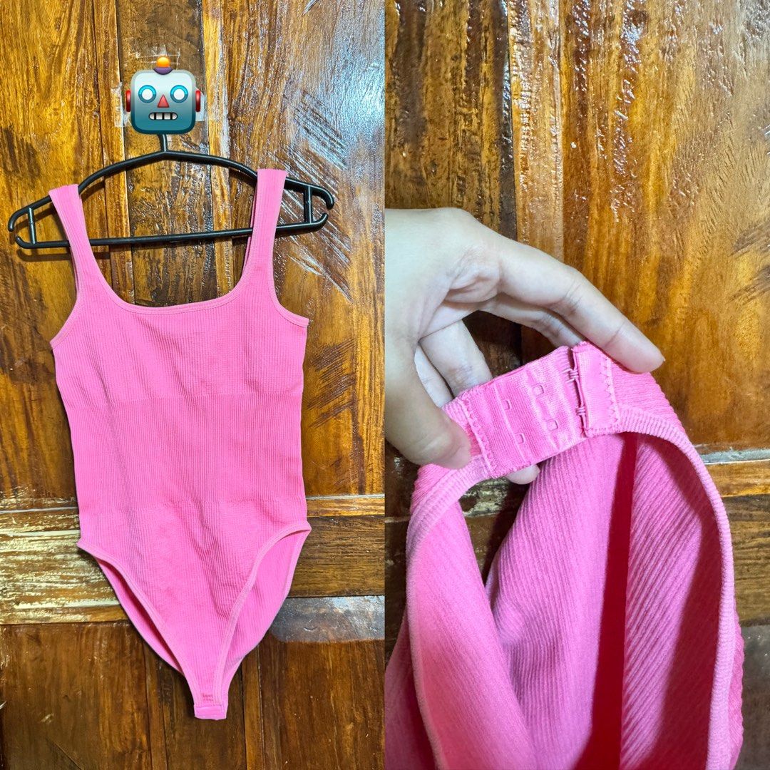 Pink Ribbed Bodysuit with Bra Clasp (Category: Sleeveless) located in Kananga. Submitted by yongggi (Listing ID 1466321325, Image 1). Description: Bright pink ribbed bodysuit with a scoop neck and tank straps. Has a hook and eye closure at the bottom gusset for easy wear. Stretchy ribbed material all over..