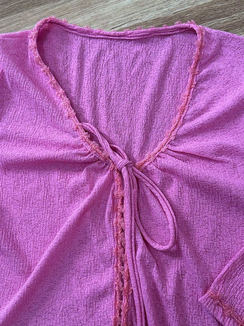 Pink textured long sleeve tie-front top (Category: Longsleeves) located in Manila. Submitted by allana18 (Listing ID 1466217645, Image 3). Description: Bright pink textured blouse with three-quarter sleeves. Tie-front detail right below the V-neckline. Delicate scalloped trim along the neckline, center front placket, and sleeve cuffs. Soft crinkled fabric all over. Easy to throw on with jeans or a skirt..