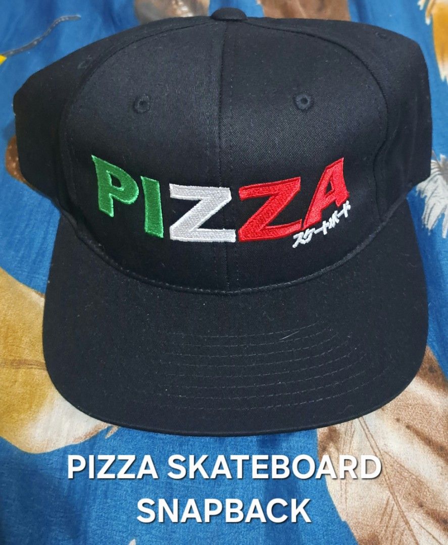 Pizza Skateboards Snapback Cap Black (Category: Caps & Hats) located in San Fernando, Camarines Sur. Submitted by ladderaya (Listing ID 1466232175, Image 1). Description: - Brand: Pizza Skateboards - Style: Black snapback hat with adjustable plastic strap - Design: Bold 'PIZZA' embroidery in green, white, and red with Japanese characters - Details: Classic green underbrim and clean interior lining with brand tag - Condition: Brand new with origin