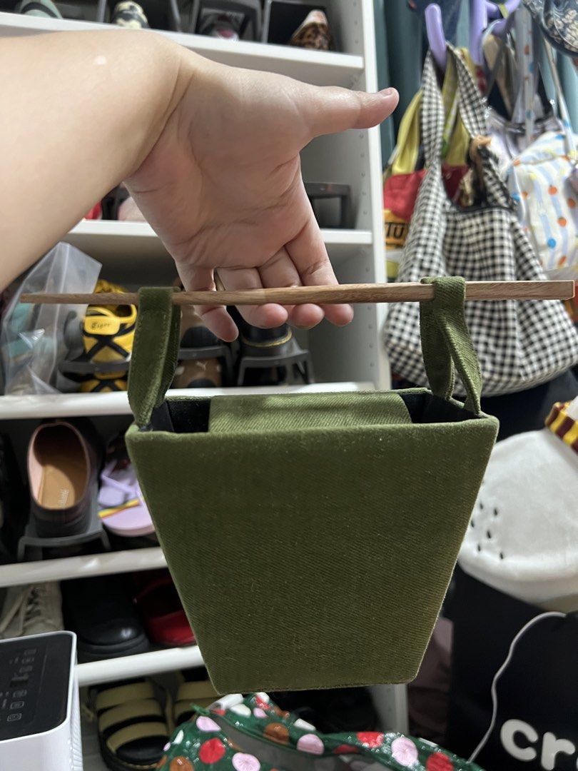 play nice takeout bag in fern (Category: Luxury Bags & Wallets) located in Paranaque City. Submitted by guevssss (Listing ID 1466208852, Image 3). Description: - never used out, stored properly and no issues at all - no original packaging - color: fern - Brand: Play Nice - Color: Green with black fabric lining - Material: Textured fabric exterior - Closure: Magnetic snap flap - Handles: Unique dual wooden chopstick-style top handles - Shape: Stru