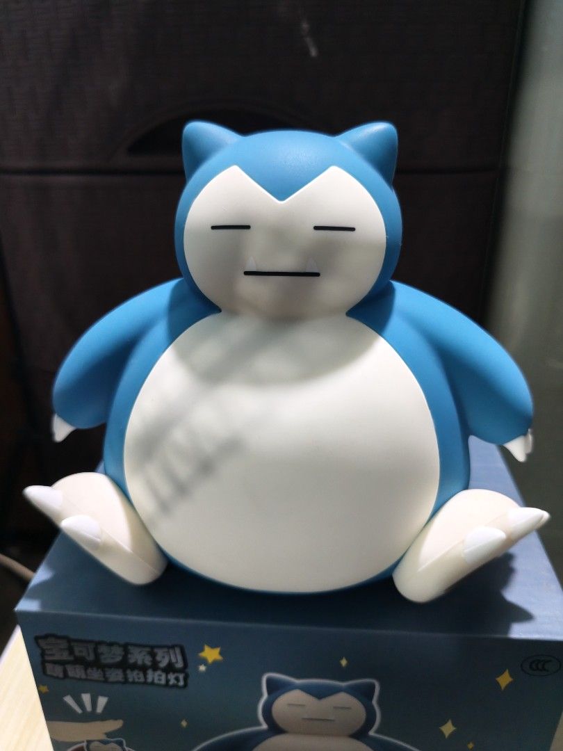 Pokémon Snorlax Tap Light Figure with Box (Category: Character Goods) located in Valenzuela. Submitted by chuwie1026 (Listing ID 1466204804, Image 2). Description: - Adorable Snorlax character lamp in a seated blue and white design - Convenient tap-to-turn-on and off feature - Built-in USB rechargeable 1200mAh battery - Power button and specifications located at the bottom - Comes complete with the original packaging box as shown.