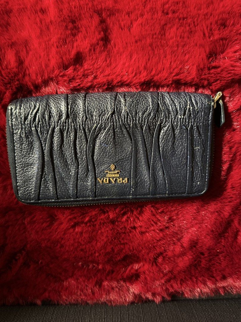 Prada Gaufre Zip Around Wallet Blue Leather (Category: Luxury Bags & Wallets) located in Quezon City. Submitted by shopaholic.kart2021 (Listing ID 1466231721, Image 1). Description: - Brand: Prada - Color: Navy Blue - Material: Textured gaufre quilted leather - Hardware: Gold-tone with metal logo lettering - Closure: Zip-around - Interior: Multiple card slots, slip compartments, and zippered coin pocket - Hallmarks: Stamped Prada Milano and Made 