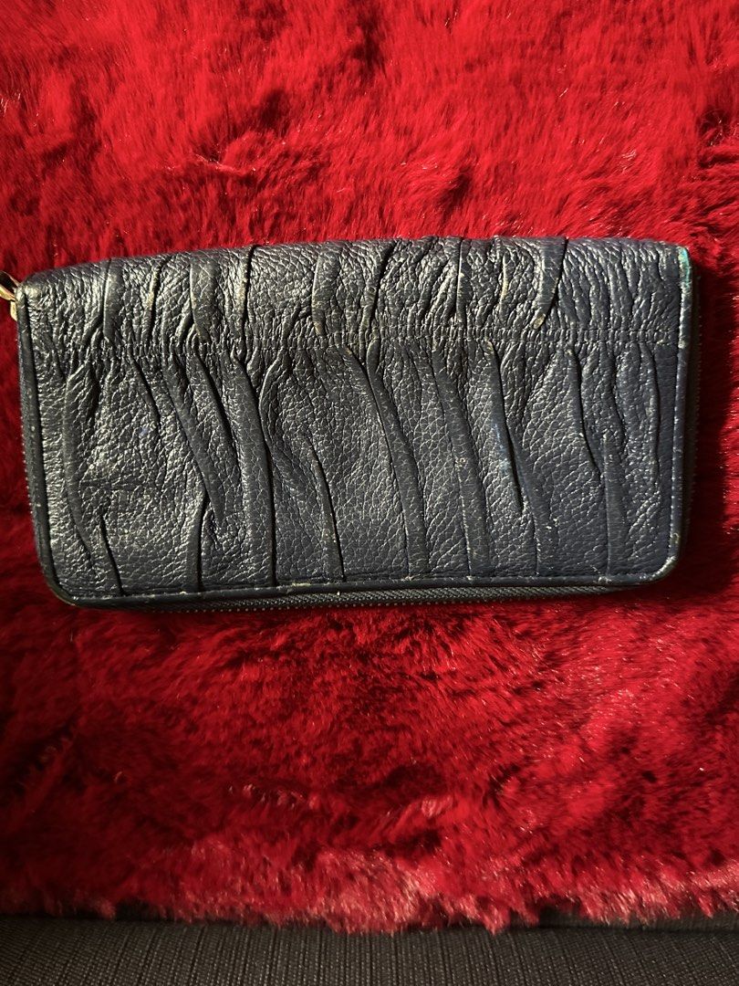 Prada Gaufre Zip Around Wallet Blue Leather (Category: Luxury Bags & Wallets) located in Quezon City. Submitted by shopaholic.kart2021 (Listing ID 1466231721, Image 2). Description: - Brand: Prada - Color: Navy Blue - Material: Textured gaufre quilted leather - Hardware: Gold-tone with metal logo lettering - Closure: Zip-around - Interior: Multiple card slots, slip compartments, and zippered coin pocket - Hallmarks: Stamped Prada Milano and Made 