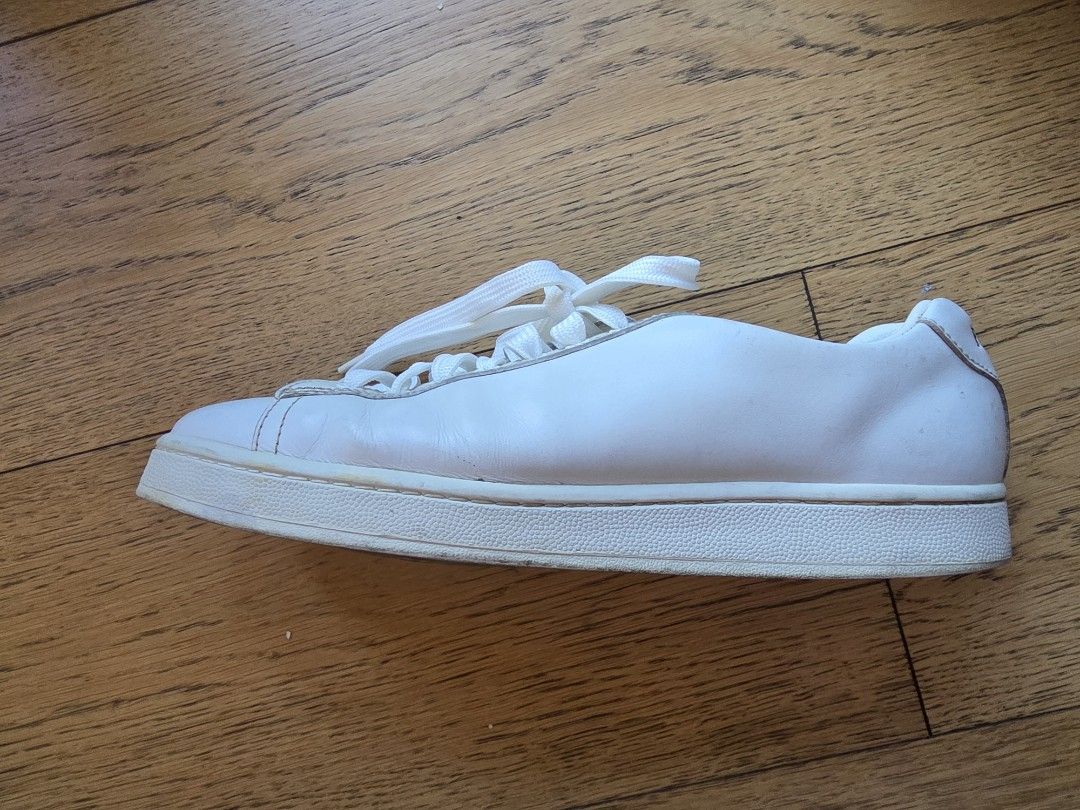 Prada Leather Sneakers White Size 43 (Category: Sneakers) located in Makati City. Submitted by happyeliz (Listing ID 1466193006, Image 2). Description: - Brand: Prada - Item: White leather low-top sneakers - Size: 43 (Made in Vietnam) - Closure: Lace-up front - Details: Signature branding on the tongue and insoles - Condition: Normal creasing on uppers from wear, soles have plenty of life left - Style: Clean, versatile look that goes with everyth