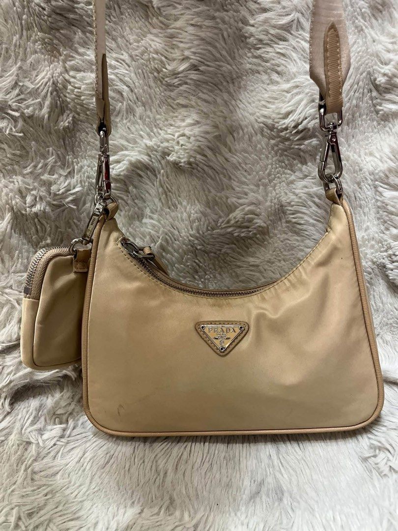 Prada Re-Edition 2005 Nylon Beige Shoulder Bag (Category: Luxury Bags & Wallets) located in San Pedro. Submitted by kianacrngn (Listing ID 1466160263, Image 1). Description: Prada Re-Edition 2005 shoulder bag in beige nylon. Includes the matching mini pouch attached to the strap and silver-tone hardware. Broad woven shoulder strap with Prada lettering. Signature triangular logo plate on front and smaller one on the pouch. Interior lined with Prad