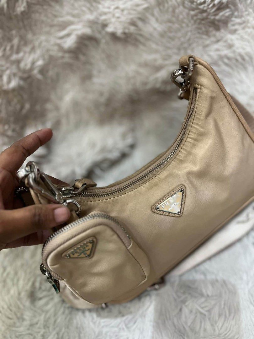 Prada Re-Edition 2005 Nylon Beige Shoulder Bag (Category: Luxury Bags & Wallets) located in San Pedro. Submitted by kianacrngn (Listing ID 1466160263, Image 2). Description: Prada Re-Edition 2005 shoulder bag in beige nylon. Includes the matching mini pouch attached to the strap and silver-tone hardware. Broad woven shoulder strap with Prada lettering. Signature triangular logo plate on front and smaller one on the pouch. Interior lined with Prad