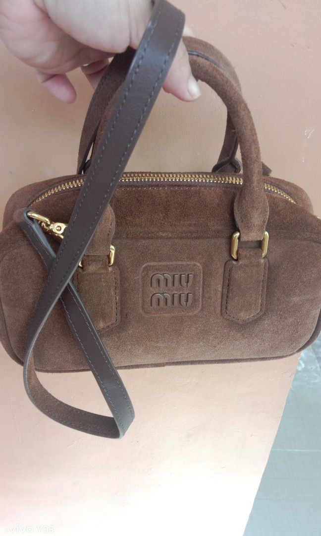 Preloved miumiu 2way bag (Category: Luxury Bags & Wallets) located in Cabuyao City. Submitted by selections888 (Listing ID 1466162117, Image 3). Description: preloved from Japan supplier small size gamuza leather color brown with sling with made missing tag expect signs of use as preloved still in good condition very elegant and unique.