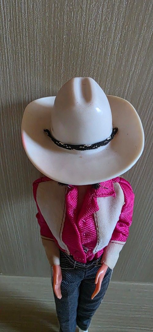 Preloved Western Barbie (1980) (Category: Kids Toys) located in Luna. Submitted by macygreyz82 (Listing ID 1466172488, Image 3). Description: Made in Taiwan Wearing preloved Western Barbie fashion #3577 with Western Barbie OG hat and boots Issue: -winking mechanism of doll not working -top with stain, flower stickers no longer available -pocket sticker on pants not available MOP: GCash MOD: J&T only Item Location: La Union.