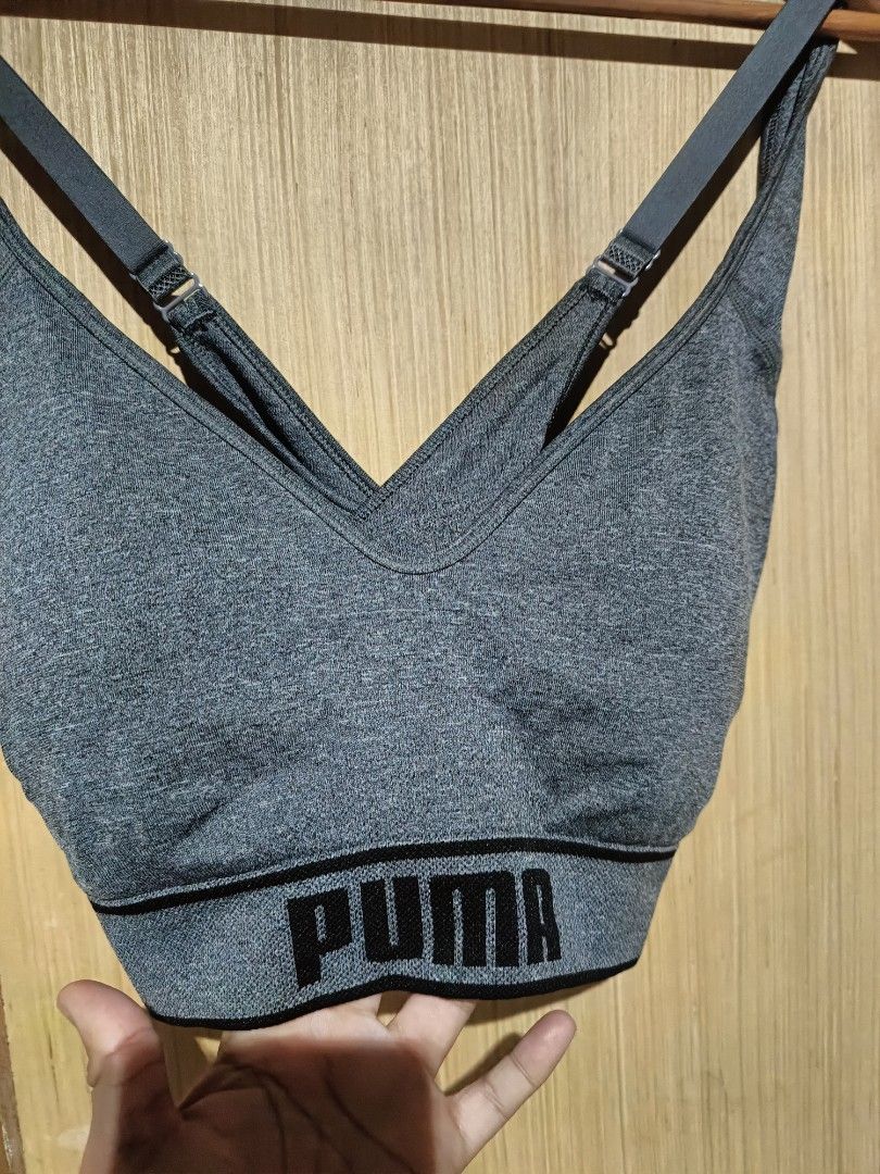 Puma Heather Grey Sports Bra (Category: Activewear) located in Angeles City. Submitted by faeyhang0223 (Listing ID 1466266901, Image 2). Description: Grey heather sports bra from Puma. V-neck style with adjustable criss-cross straps in the back. Black elastic underband featuring the bold Puma logo all around. Classic athletic piece, comfortable and supportive for workouts or daily wear. Good stretch material, clean finish, and neat stitching..