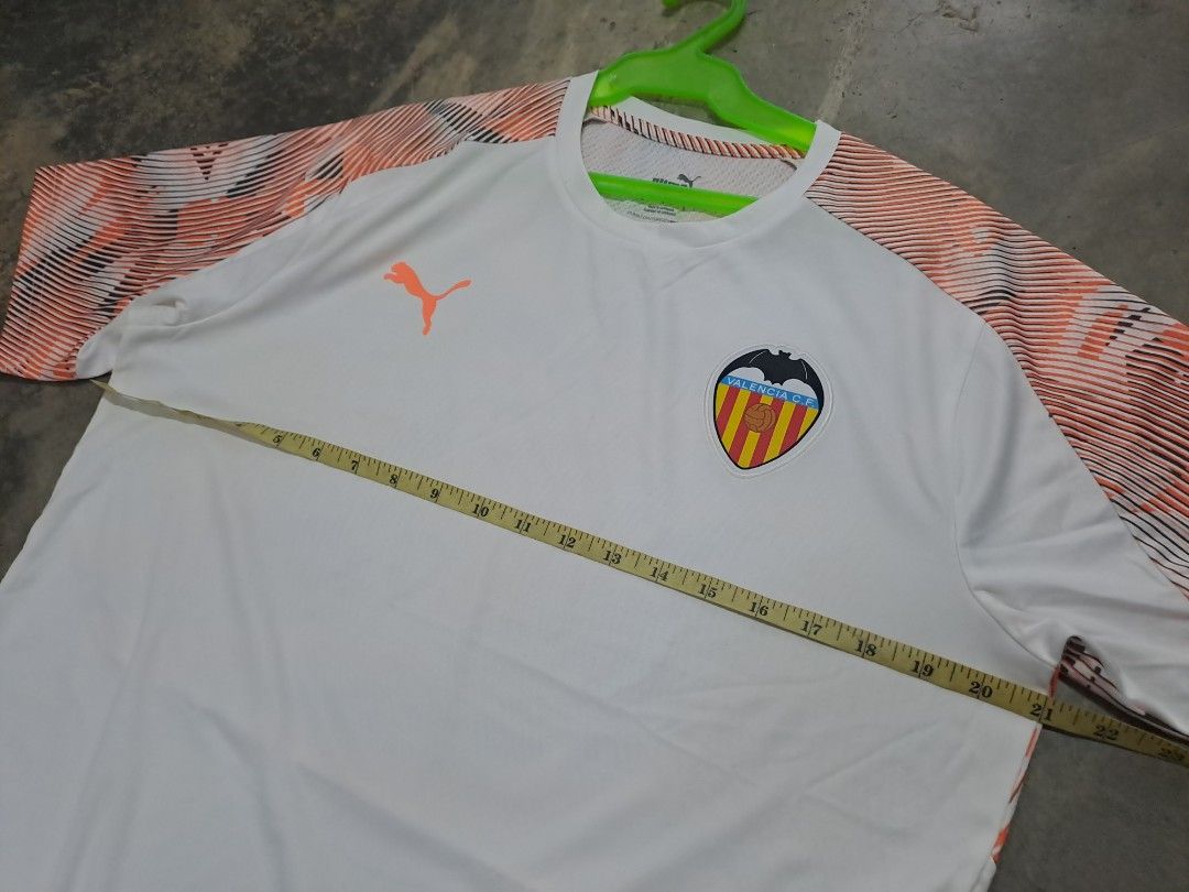 Puma Valencia CF White Orange Jersey (Category: Activewear) located in Puerto Princesa. Submitted by jercksthriftph (Listing ID 1466330519, Image 3). Description: Puma Valencia CF football jersey in white with orange patterned sleeves. Size L, made in Cambodia. Short sleeves, crew neck, dryCELL technology fabric. Club crest and Puma logo printed on the chest. Style number 756189-11..