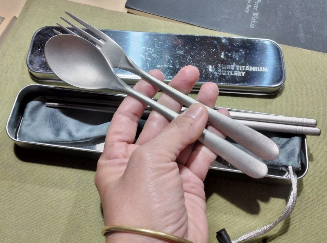 Pure Titanium Cutlery Set Spoon Fork Chopsticks with Case (Category: Dinnerware & Cutlery) located in Baguio. Submitted by tipiditis (Listing ID 1466249079, Image 1). Description: - Material: 100% Pure Titanium (Super lightweight and durable) - Set includes: Chopsticks, fork, and spoon - Inclusions: Metallic storage case and grey pouch - Best for: Camping, traveling, office, and school lunches - Condition: Brand new utensils, minor scratches on t