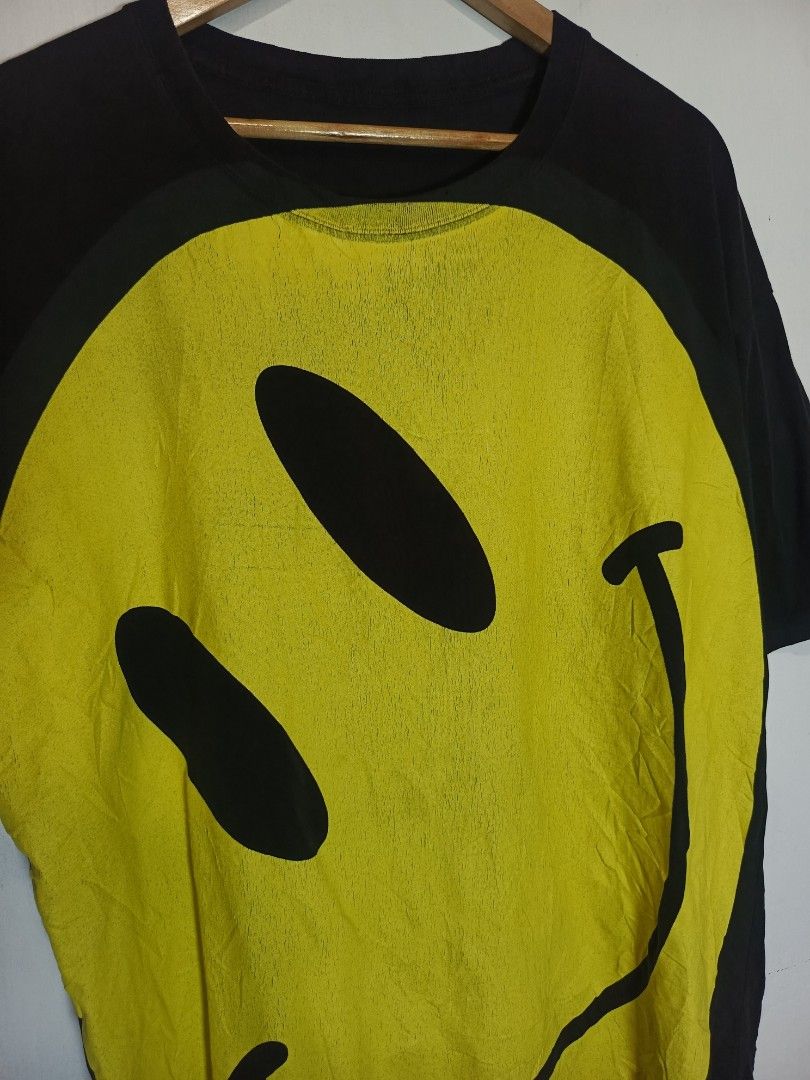RAF SIMONS SS20 OVERSIZED SMILEY TEE (Category: Tshirts & Polo Shirts ) located in Baguio. Submitted by 074thriftmania (Listing ID 1466166841, Image 2). Description: - Brand/Collection: Raf Simons SS20 - Colorway: Black and yellow with large smiley face graphic print - Size: Large (Oversized fit, short sleeves) - Material: 100% cotton, made in Turkey - Condition: Clean overall with normal wear and slight cracking on the graphic print length 33" w