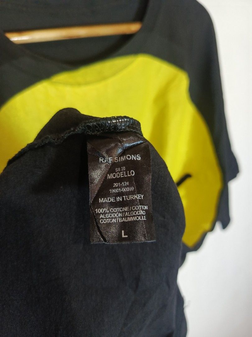 RAF SIMONS SS20 OVERSIZED SMILEY TEE (Category: Tshirts & Polo Shirts ) located in Baguio. Submitted by 074thriftmania (Listing ID 1466166841, Image 3). Description: - Brand/Collection: Raf Simons SS20 - Colorway: Black and yellow with large smiley face graphic print - Size: Large (Oversized fit, short sleeves) - Material: 100% cotton, made in Turkey - Condition: Clean overall with normal wear and slight cracking on the graphic print length 33" w