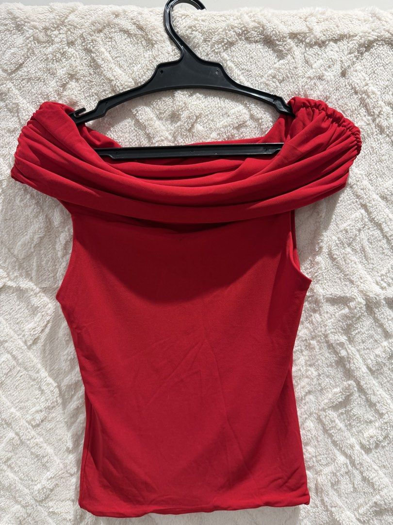 Red Off-Shoulder Draped Neck Top (Category: Blouses) located in San Juan City. Submitted by ich711 (Listing ID 1466272639, Image 1). Description: - Color: Bright red - Style: Fitted, off-the-shoulder with dramatic draped neckline and sleeveless base - Details: Textured ruching on sleeves - Fabric: Soft, stretchy material that hugs the body - Occasion: Perfect for a night out or dinner date - Pairing: Looks great with high-waisted jeans or a skirt