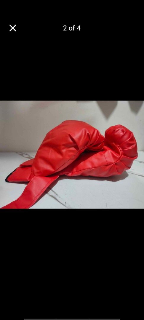 Red training boxing gloves with wrist strap (Category: Combat Sports) located in Manila. Submitted by billythekid05 (Listing ID 1466278328, Image 2). Description: - Vibrant red boxing gloves made of durable synthetic leather - Features soft padding for comfortable hand protection - Secure velcro wrist strap closure with stylish black trim - Impeccable, clean condition with zero scuffs or marks - Ideal for fitness workouts, mitt work, and heavy ba