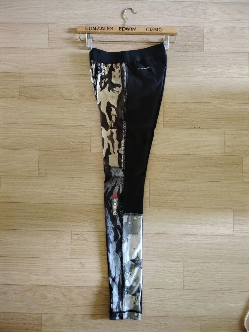 Reebok Camo Performance Tights Leggings Size M (Category: Activewear) located in Nasipit. Submitted by edwingonzales498-69377 (Listing ID 1466232270, Image 3). Description: - Brand: Reebok - Style: Performance tights with mixed camo and star print - Size: Medium (Waist: 26"–30", Length: 35") - Material: 88% Polyester, 12% Elastane with Speedwick technology - Features: Elastic waistband, tight fit for ultimate workout support - Condition: Excellen