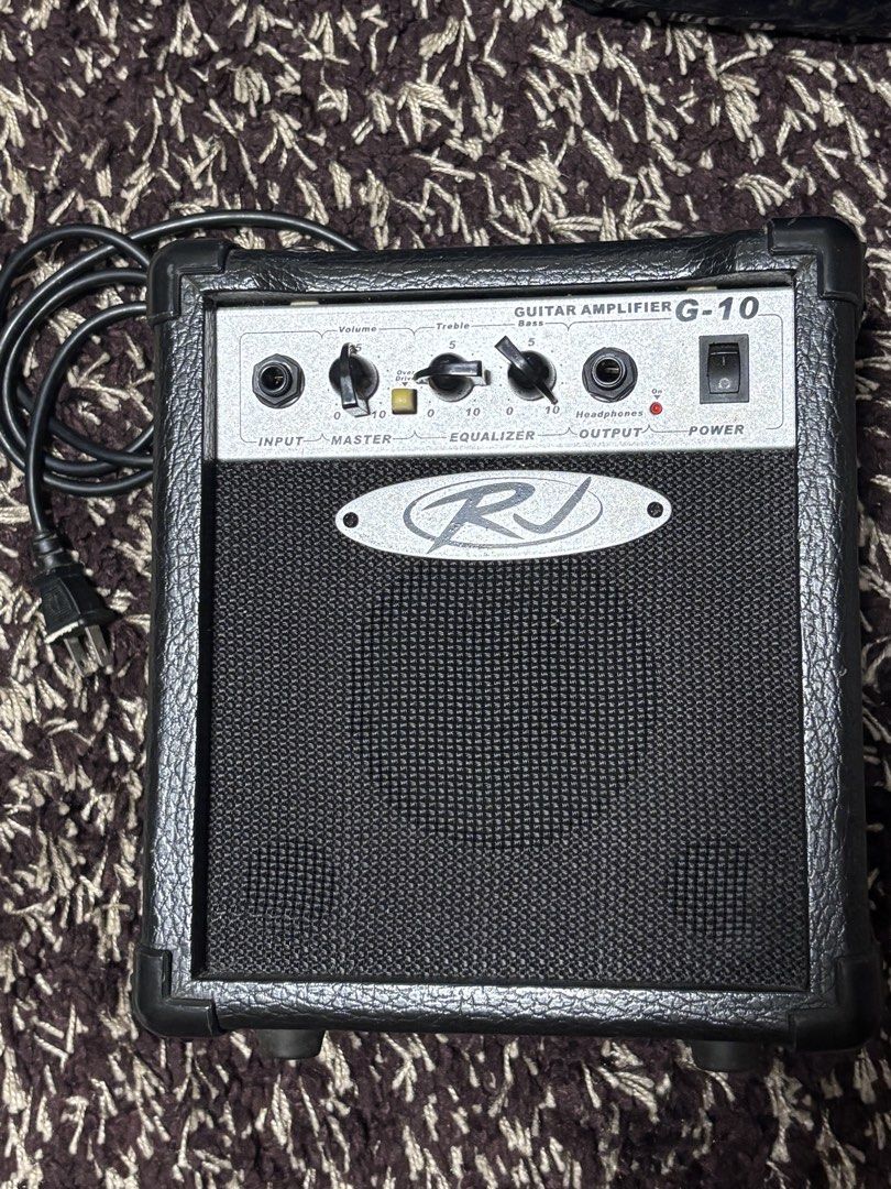 RJ G-10 Guitar Amplifier 10W (Category: Musical Instruments) located in Manila. Submitted by silentdeer.537e56 (Listing ID 1466260209, Image 1). Description: Loc: Sampaloc, Manila Delivery or meet up only - Brand: RJ (Model: G-10) - Power Output: 10W - Controls: Volume, Master, Overdrive, Treble, and Bass EQ knobs - Inputs/Outputs: Input jack and Headphone output.