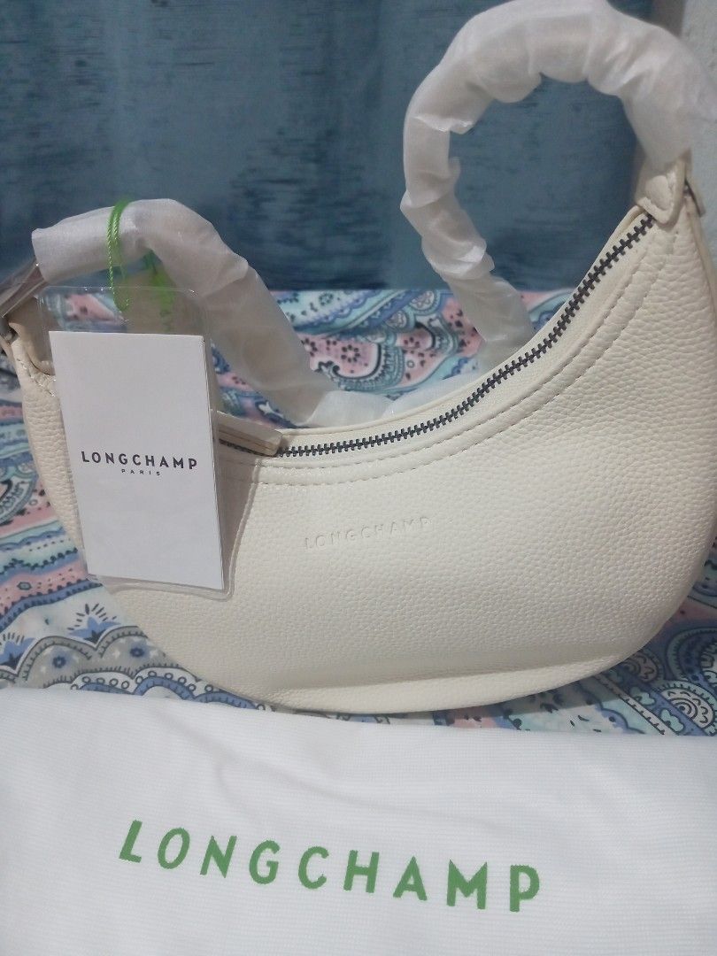 RoseCrescent Shoulder Bag Off-White (Category: Luxury Bags & Wallets) located in Manila. Submitted by tuesdaymari (Listing ID 1466250469, Image 1). Description: -Roseau Longchamp hobo style shoulder bag in stylish off-white grained leather - Features a curved zip-top closure with sleek dark metal hardware and embossed front logo - Comes complete with original hangtag and signature white dust bag with green lettering - Perfect luxury everyday bag 