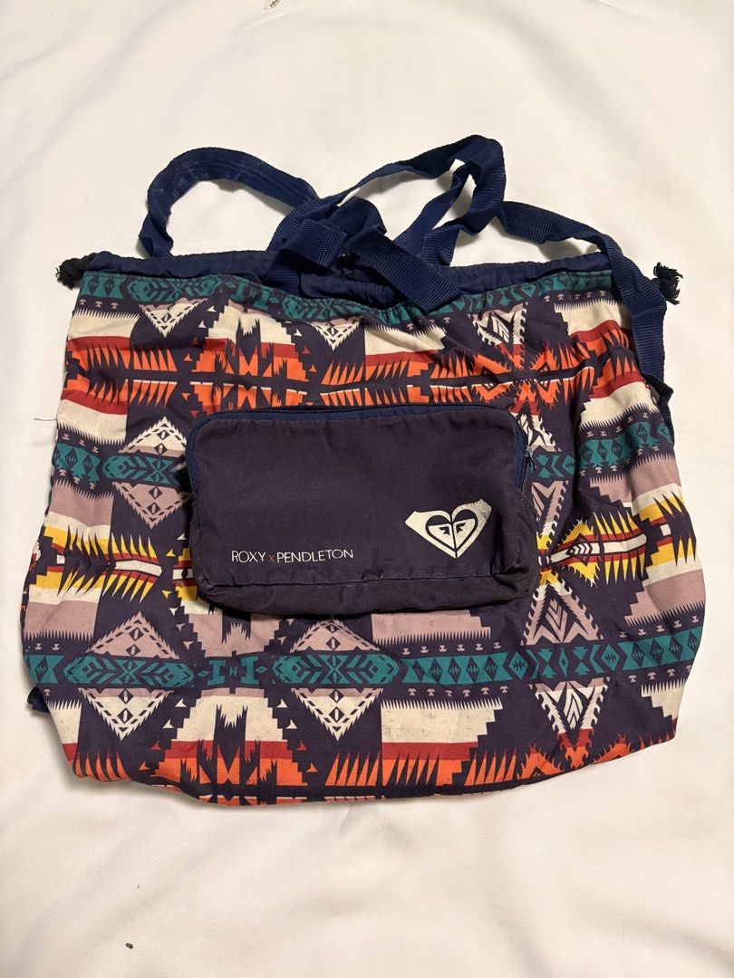 Roxy x Pendleton Convertible Backpack Tote Bag (Category: Backpacks) located in Mandaluyong City. Submitted by sarisaringtinda (Listing ID 1466321994, Image 1). Description: - Authentic Roxy x Pendleton collaboration - Eye-catching geometric southwest pattern in navy, orange, yellow, and teal - Convertible design: wear as a backpack or carry as a tote - Packable design: folds into its own built-in front zip pocket into a compact pouch - Drawstrin