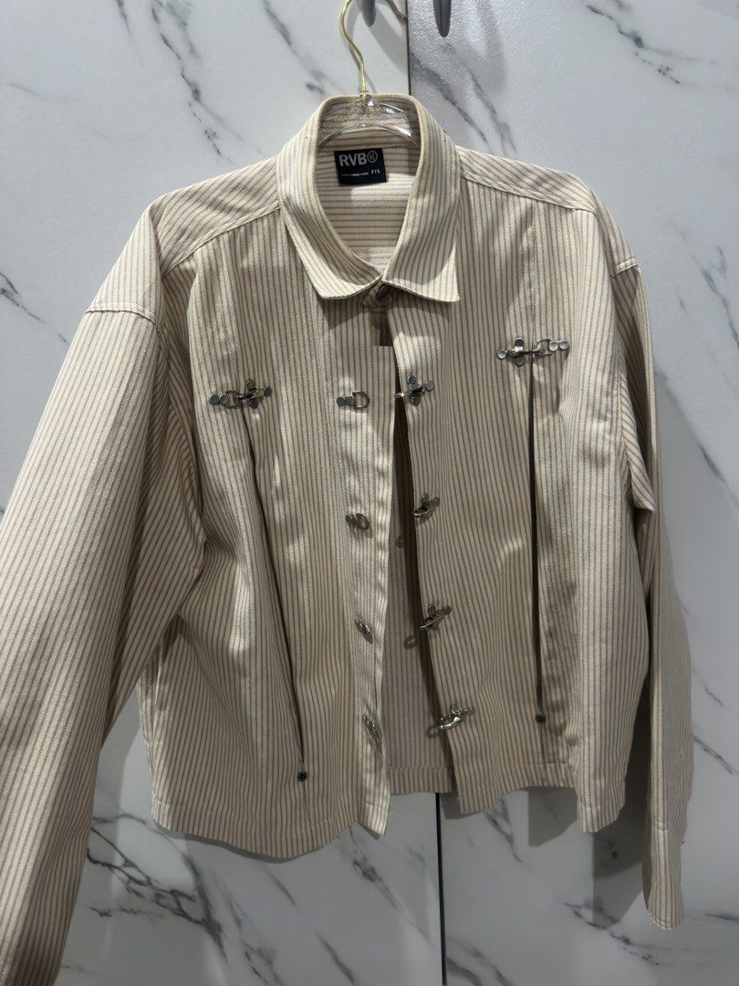 RVB Striped Chinese Inspired Yellow Jacket (Category: Coats, Jackets and Outerwear) located in Baguio. Submitted by miss_misery (Listing ID 1466255386, Image 2). Description: - Brand: RVB (Tags attached) - Made in Vietnam - Color/Pattern: Beige and white stripes - Design: Collared neckline, button-up front, unique metal chest clasp, and leather back patch - Sleeves: Long sleeves with button cuffs - Fit: Relaxed fit, ideal for layering during tran