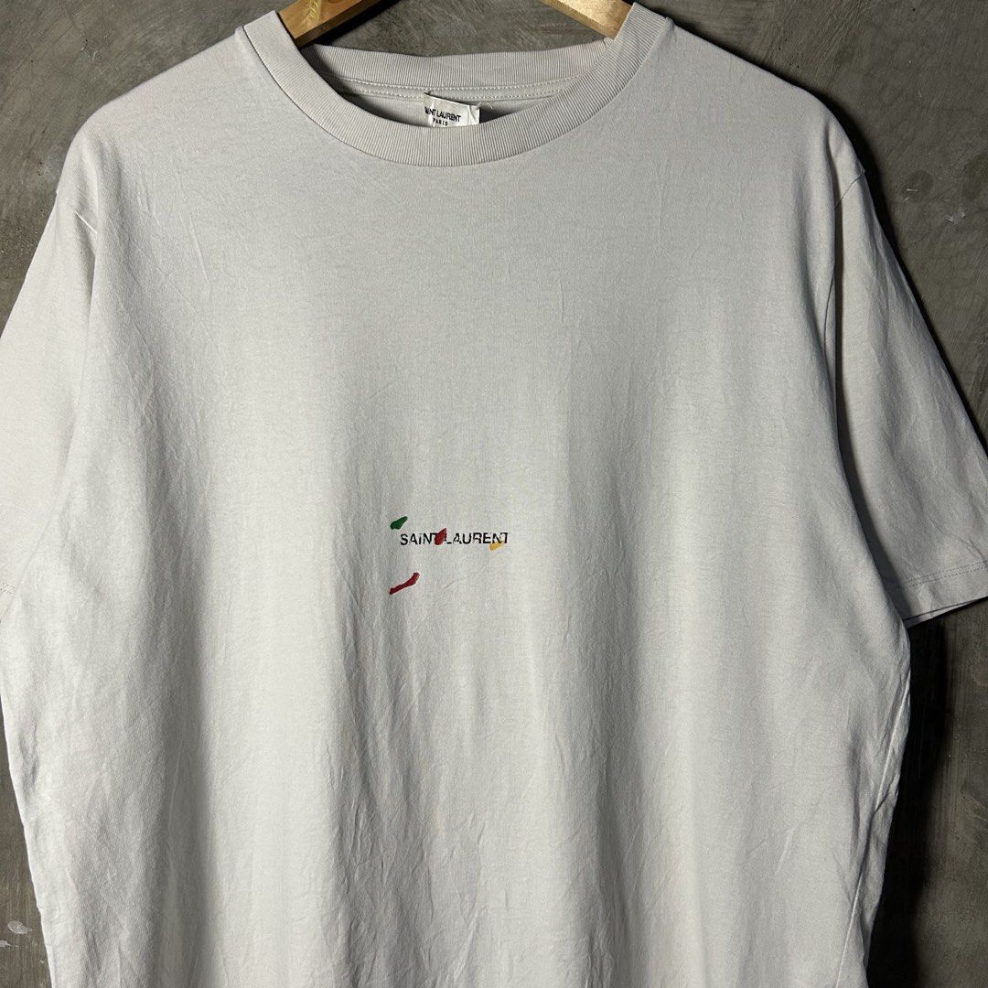 Saint Laurent Paris - Rive Gauche “Painter” T-shirt (Category: Luxury Apparel) located in Tayabas. Submitted by streetdepartment (Listing ID 1466311234, Image 2). Description: Saint Laurent Paris - Rive Gauche “Painter” T-shirt Excellent condition Flaw/s: loose stitch on neck tag Size: Small fits Large Measurements (inches): Width: 22.5” Length: 28.5” Price: 1,680 + shipping fee Dm to purchase! Note: Manage your expectations as you are dealing wi