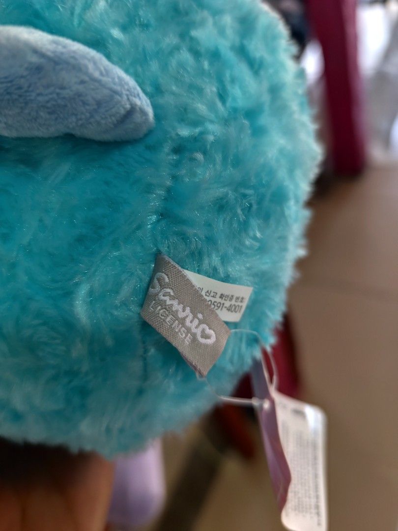 Sanrio Hangyodon fluffy blue plush toy (Category: Plushies & Soft Toys) located in Cordova. Submitted by bsb.streetluxvintage.clothing (Listing ID 1466179966, Image 3). Description: - 100% Authentic Sanrio Hangyodon plushie in bright blue - Super soft, furry texture with cute pink lips - Detailed embroidered scales, side fins, and back spikes - Original tag attached with official Sanrio license label - Perfect for Sanrio collectors and gift-givin