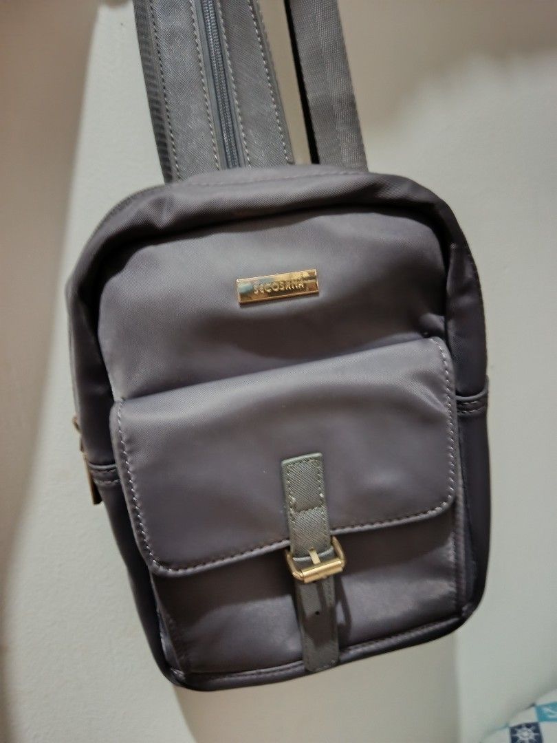 Secosana Gray Convertible Sling Backpack (Category: Backpacks) located in Pasay City. Submitted by pitchiiieee_ (Listing ID 1466253080, Image 2). Description: Slightly Negotiable - Brand: Secosana - Color: Gray - Style: Mini backpack with convertible zip straps - Closure & Hardware: Buckle closure on front pocket with chic gold hardware - Storage: Interior slip pockets, interior zipper compartment, and exterior back zippered pocket - Condition: C