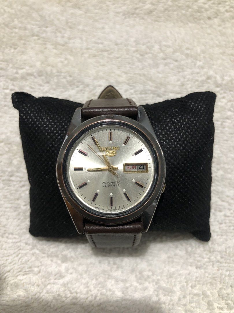 Seiko 5 Automatic 21 Jewels Watch (Category: Men's Watches) located in Dagupan City. Submitted by alex123345 (Listing ID 1466317422, Image 3). Description: - Brand: Seiko 5 Automatic - Movement: 21 Jewels Mechanical Movement - Dial: Silver-toned with elegant gold hands and hour markers - Features: Day and date window at 3 o'clock - Case Back: Clear exhibition glass to view the movement - Strap: Premium brown genuine leather with silver buckle - C