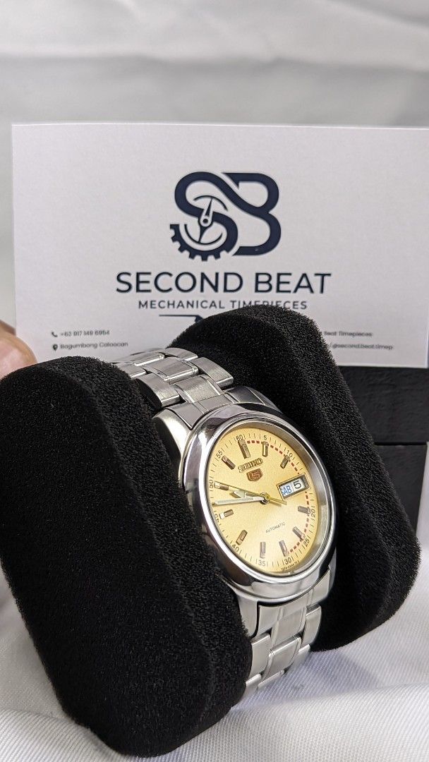 Seiko 5 Automatic Watch Yellow Dial (Category: Men's Watches) located in Caloocan City. Submitted by bimgol (Listing ID 1466287472, Image 2). Description: - Brand: Seiko 5 - Movement: Mechanical automatic - Dial: Vibrant yellow sunburst dial with day and date window at 3 o'clock - Hands & Markers: Silver-tone - Case: Polished bezel with clean crystal - Strap: Original stainless steel bracelet with signed Seiko 5 clasp - Condition: Excellent, read