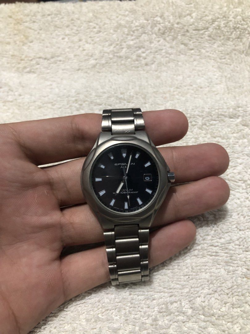 Seiko Alba Epsilon Solar Watch (Category: Men's Watches) located in Binmaley. Submitted by alex123345 (Listing ID 1466315682, Image 1). Description: - Seiko Epsilon Alba Titanium Brand: Alba (Sub-brand of Seiko) Model: Epsilon Alba Titanium Reference: V145-0E60 Watch Movement: Seiko Caliber V145 Solar Quartz Power Source: Solar Powered / Light-driven Dial Details: Black Dial, Date Window Case and Bezel: Titanium Water Resistance: 10 Bar (100 Mete