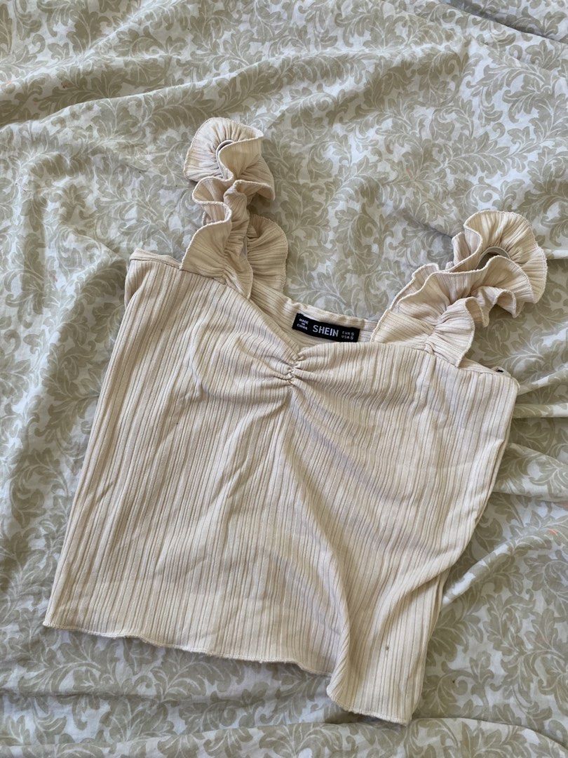 SHEIN Beige Ruffle Strap Ribbed Crop Top Size S (Category: Sleeveless) located in Rizal. Submitted by mochimchim29 (Listing ID 1466301443, Image 1). Description: - Brand: SHEIN - Size: EUR S / USA S - Color: Beige - Details: Thick ruffled straps, sweetheart neckline with ruched center, lettuce hem - Material: Soft and stretchy ribbed fabric - Condition: Worn once, still in great shape.