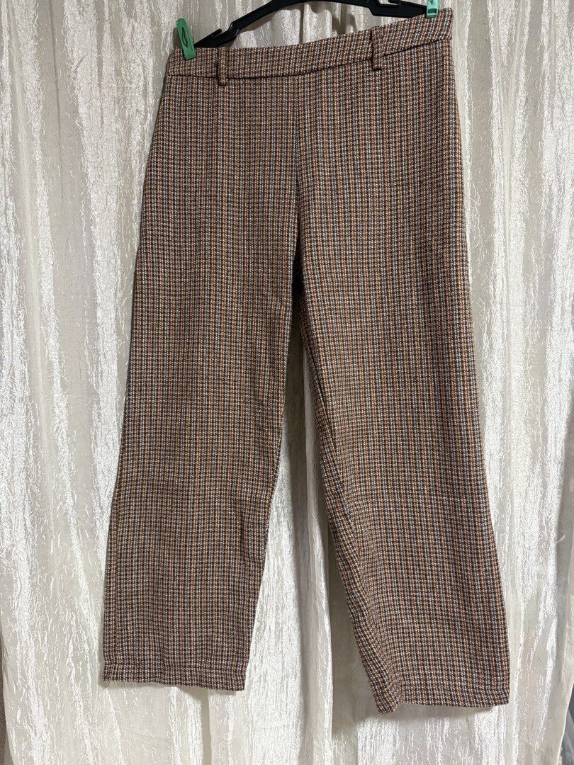Shein Brown Houndstooth Plaid Trousers Size L (Category: Trousers) located in Manila. Submitted by lilomochi (Listing ID 1466291761, Image 3). Description: Brown houndstooth plaid trousers from Shein. Features a patterned plaid design with subtle blue and orange threads running through. Size L, EUR 40/42, US 8/10. Belt loops attached at the waistband. Straight cut style, great for casual days or office wear..