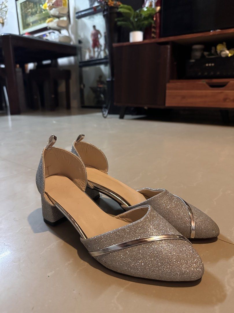 Silver Glitter Block Heels Size 40 (Category: Heels) located in Manila. Submitted by mysticdog_8e9243 (Listing ID 1466181535, Image 1). Description: - Size: 40 (marked on sole) - Color/Design: Silver glitter with metallic silver curved stripe - Heel: Comfortable low block heel - Toe: Pointed toe design - Style: Ankle strap cutout - Condition: Excellent, barely any wear with clean insides and soles.