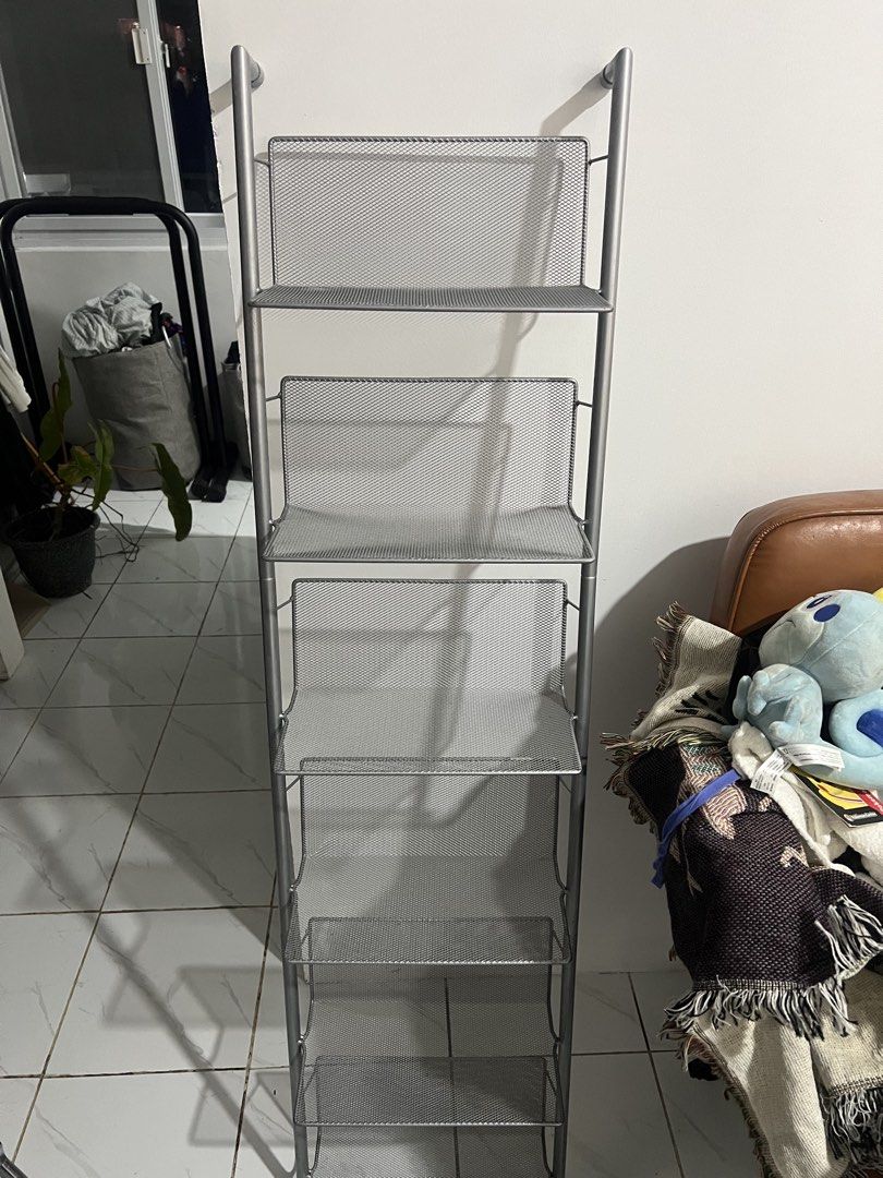 Silver metal mesh 6-tier leaning wall shelf rack (Category: Shelves, Cabinets & Racks) located in Manila. Submitted by magnuscastle (Listing ID 1466293798, Image 2). Description: - 6-tier vertical storage rack in a sleek silver metal mesh design - Space-saving leaning setup with secure top wall mounting - Open wire mesh provides easy visibility and quick access to items - Narrow profile fits perfectly in tight living room, bedroom, or bathroom sp