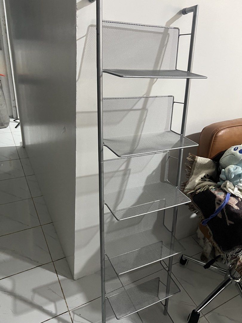 Silver metal mesh 6-tier leaning wall shelf rack (Category: Shelves, Cabinets & Racks) located in Manila. Submitted by magnuscastle (Listing ID 1466293798, Image 1). Description: - 6-tier vertical storage rack in a sleek silver metal mesh design - Space-saving leaning setup with secure top wall mounting - Open wire mesh provides easy visibility and quick access to items - Narrow profile fits perfectly in tight living room, bedroom, or bathroom sp