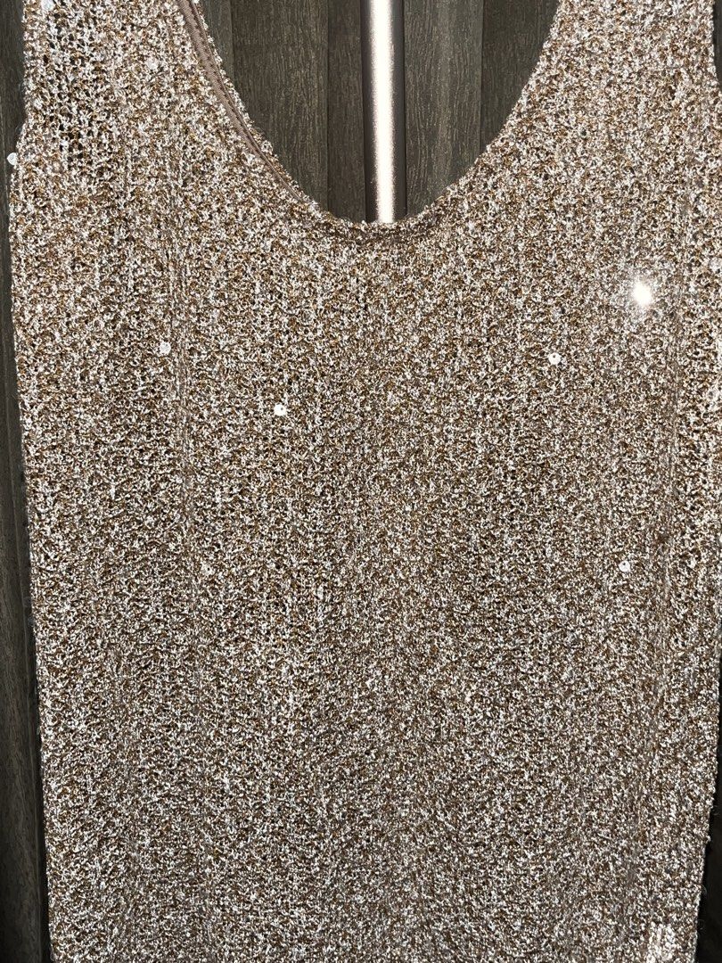 Sparkling Sequined Tank Top (Category: Sleeveless) located in Pasig City. Submitted by kathgracee (Listing ID 1466268485, Image 2). Description: - Brand/Style: KSTM sparkling sequined tank top - Design: Scoop neckline with a glamorous see-through knit style - Detail: Shimmery gold and metallic thread all over - Versatility: Great for parties or evening outings - Styling: Easy to layer with jackets or wear on its own Size M Tried on only .